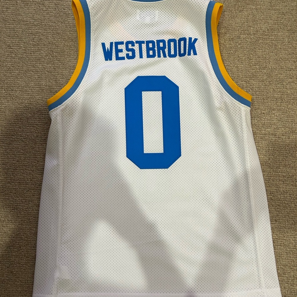 White Basketball Jersey with Blue and Yellow Accents. Russel Westbrook UCLA Jers